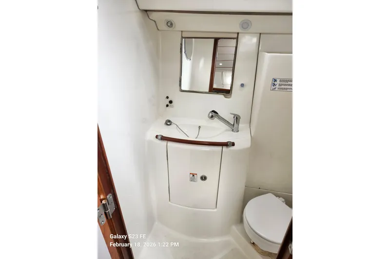 Slide: The Image of Bathroom interior of 2005 Beneteau Oceanis Clipper 393 yacht, featuring sink and mirror. - 18