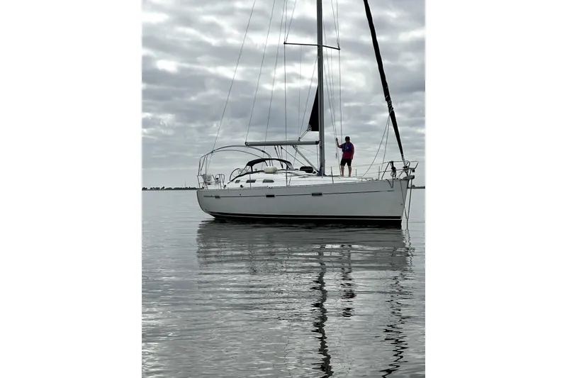 Slide: The Image of 2005 Beneteau Oceanis Clipper 393 sailboat on calm water with cloudy sky. - 24
