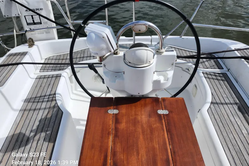 Slide: The Image of Steering wheel of 2005 Beneteau Oceanis Clipper 393 sailboat, featuring wooden cockpit table. - 4