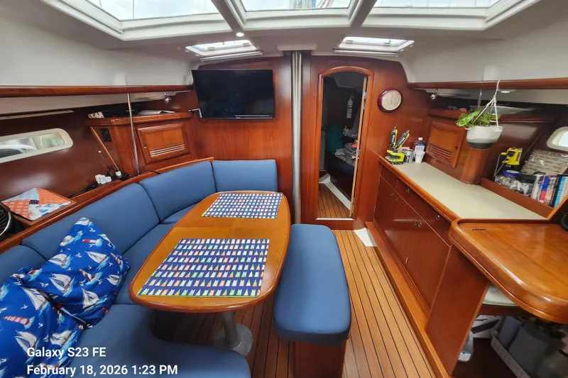 Slide: The Image of Interior of 2005 Beneteau Oceanis Clipper 393 yacht with cozy seating and wooden finishes. - 6