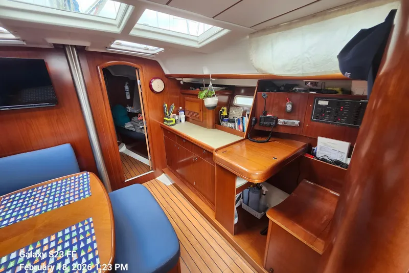 Slide: The Image of Interior of 2005 Beneteau Oceanis Clipper 393 sailboat with wood finish and navigation station. - 7