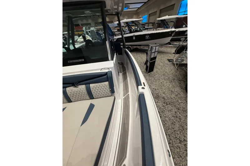 Slide: The Image of 2026 Monterey Elite 25 OB boat interior at a showroom display. - 10