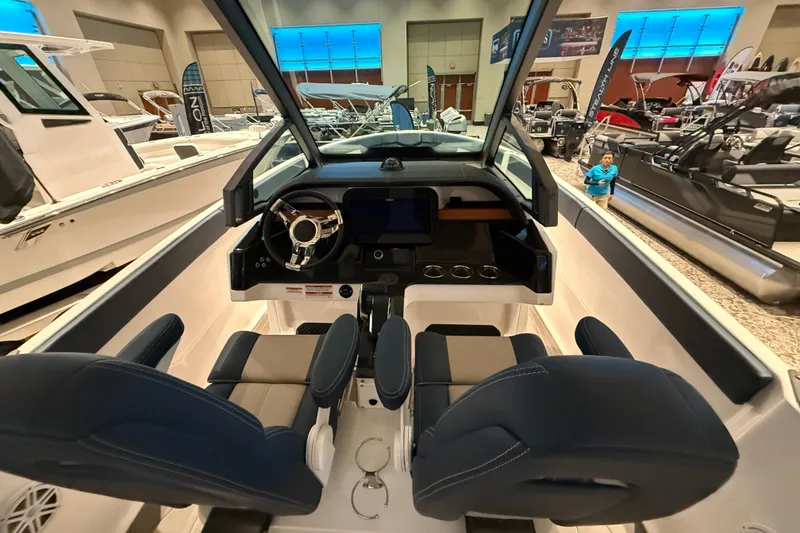 Slide: The Image of Interior view of 2026 Monterey Elite 25 OB boat at a showroom display. - 11