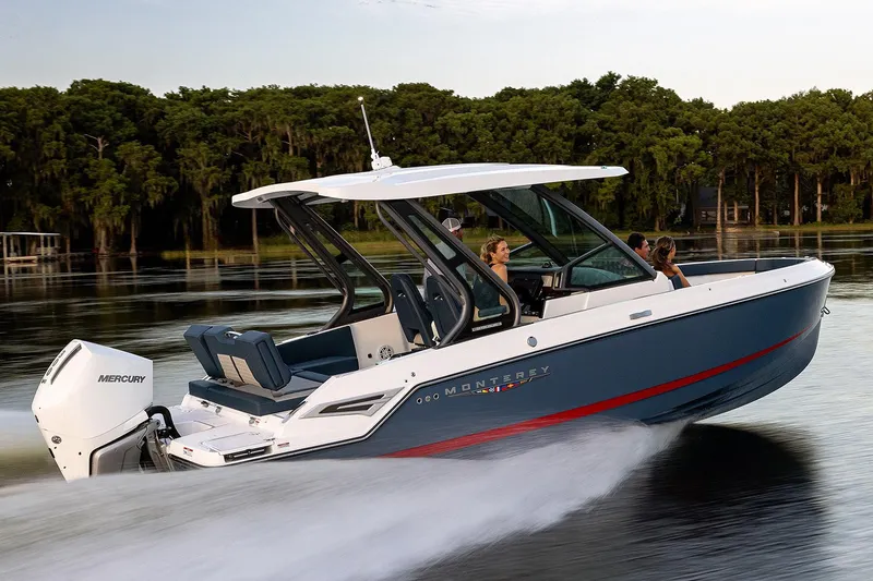 Slide: The Image of Manufacturer Provided Image: 2026 Monterey Elite 25 OB boat cruising on a serene lake. - 12