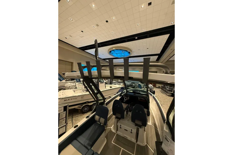 Slide: The Image of 2026 Monterey Elite 25 OB boat interior at an indoor showroom display. - 5