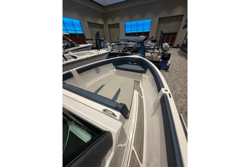 Slide: The Image of 2026 Monterey Elite 25 OB boat interior at a showroom display. - 6