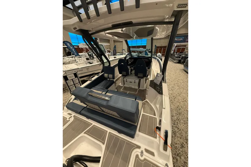 Slide: The Image of 2026 Monterey Elite 25 OB boat interior with modern seating and dashboard. - 7