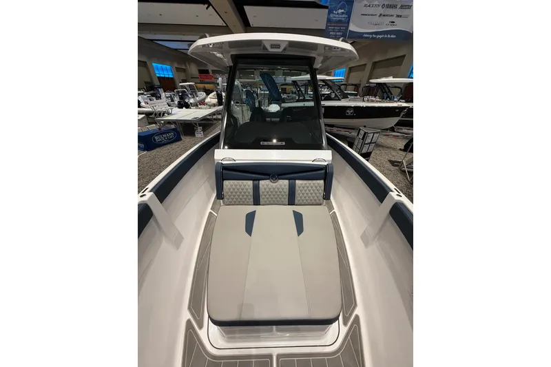 Slide: The Image of 2026 Monterey Elite 25 OB boat interior at a showroom display. - 8