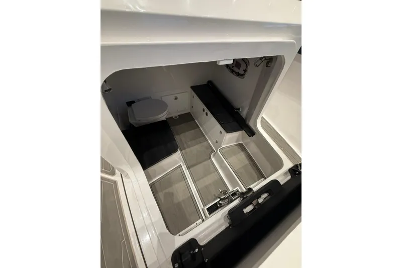 Slide: The Image of 2026 Monterey Elite 25 OB boat interior with seating and toilet. - 9