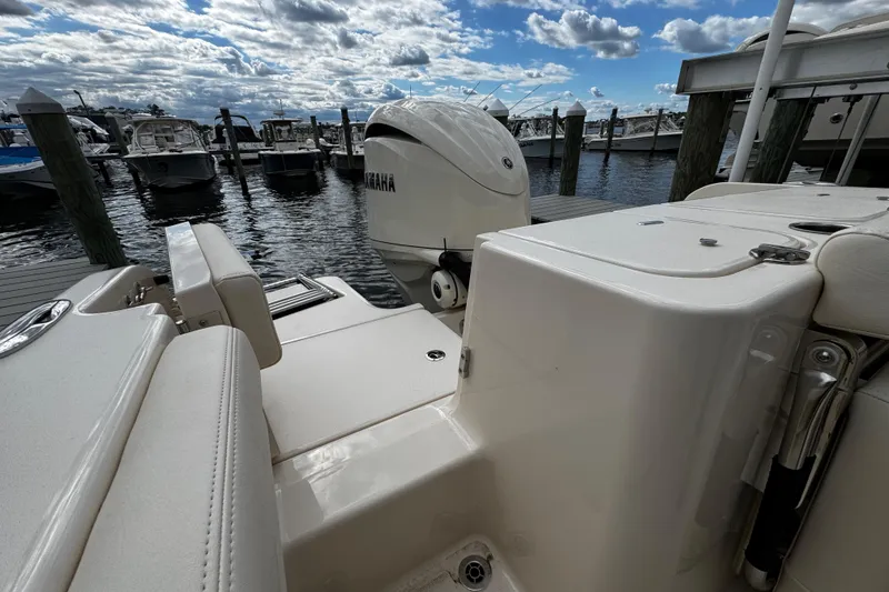 Slide: The Image of 2026 Grady-White Freedom 235 boat docked, featuring Yamaha outboard motor. - 13