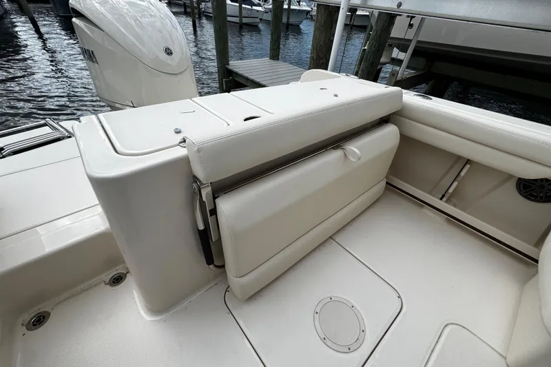 Slide: The Image of 2026 Grady-White Freedom 235 boat interior with seating and storage features. - 14