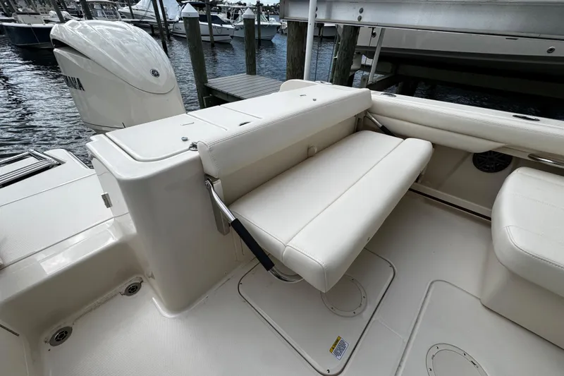 Slide: The Image of 2026 Grady-White Freedom 235 boat interior with foldable seating and Yamaha engine. - 15