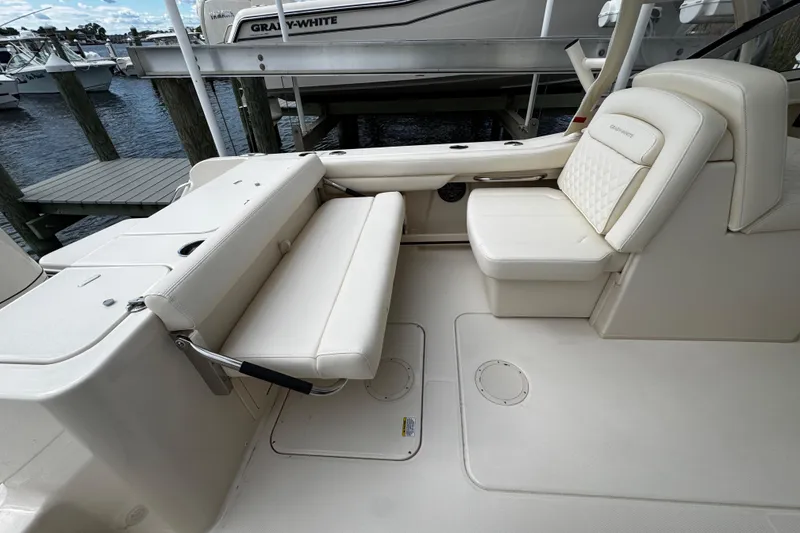 Slide: The Image of 2026 Grady-White Freedom 235 boat interior with white seating and deck. - 16