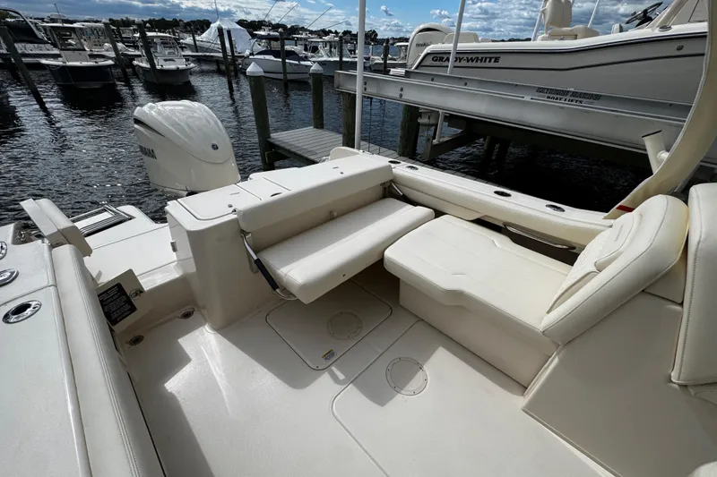 Slide: The Image of 2026 Grady-White Freedom 235 boat interior with seating, docked at marina. - 17