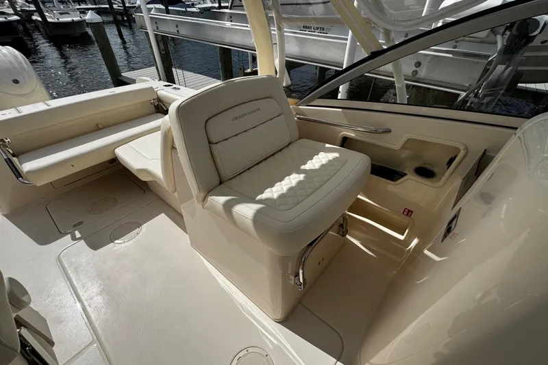 Slide: The Image of 2026 Grady-White Freedom 235 boat interior with cushioned seating and sleek design. - 20