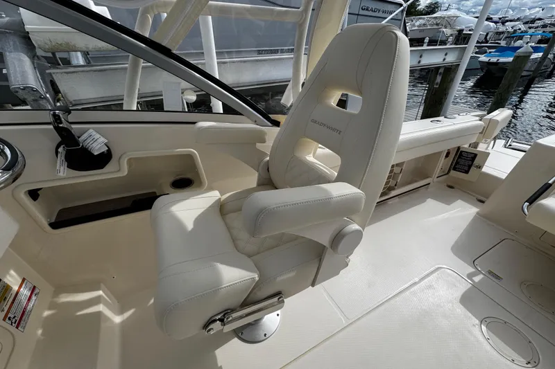 Slide: The Image of Captain's chair on 2026 Grady-White Freedom 235 boat, docked at marina. - 27