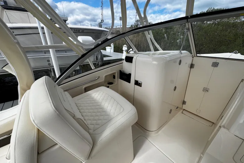 Slide: The Image of Interior of 2026 Grady-White Freedom 235 boat with white seating and sleek design. - 31
