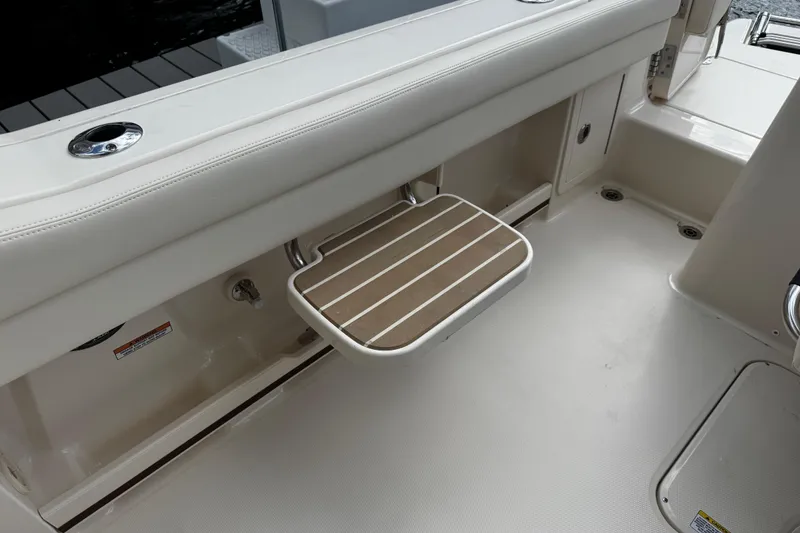 Slide: The Image of 2026 Grady-White Freedom 235 boat interior with foldable seat and sleek design. - 37