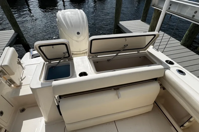 Slide: The Image of 2026 Grady-White Freedom 235 boat with open storage compartments and sleek design. - 41