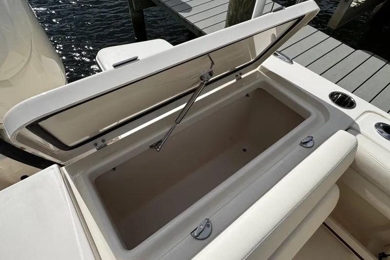 Slide: The Image of Open storage compartment on 2026 Grady-White Freedom 235 boat, dockside view. - 42