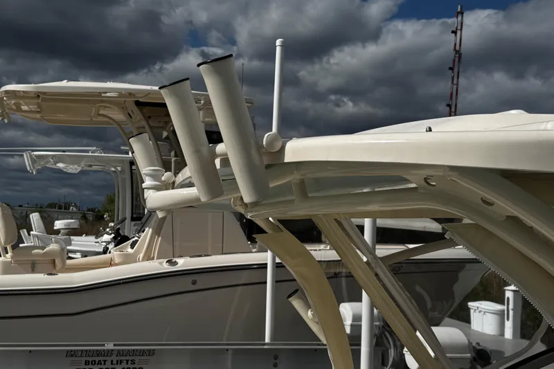 Slide: The Image of 2026 Grady-White Freedom 235 boat docked under cloudy skies. - 45