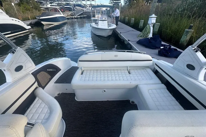 Slide: The Image of 2021 Cobalt R3 boat interior with white seating at a marina dock. - 10