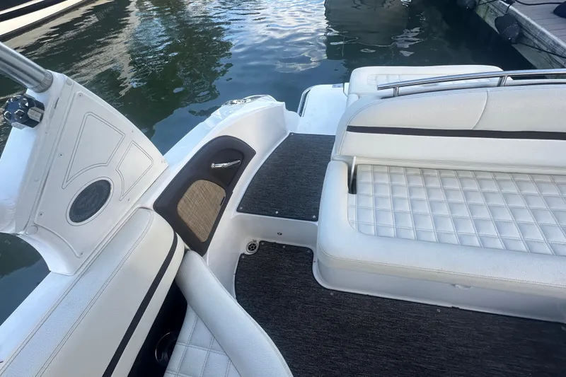 Slide: The Image of 2021 Cobalt R3 boat interior with white cushioned seating and water view. - 11