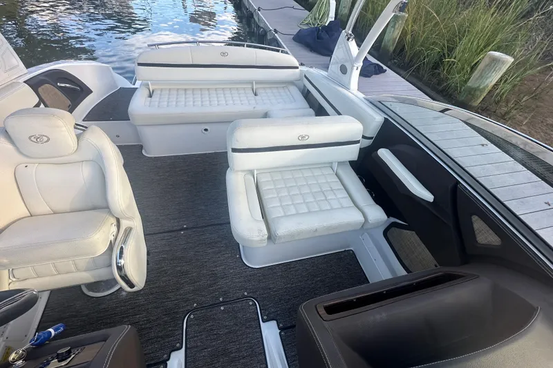 Slide: The Image of 2021 Cobalt R3 boat interior with white seating and sleek design by the dock. - 12