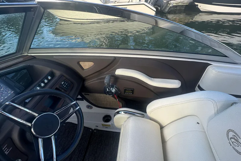 Slide: The Image of Interior of a 2021 Cobalt R3 boat, featuring steering wheel and control panel. - 17