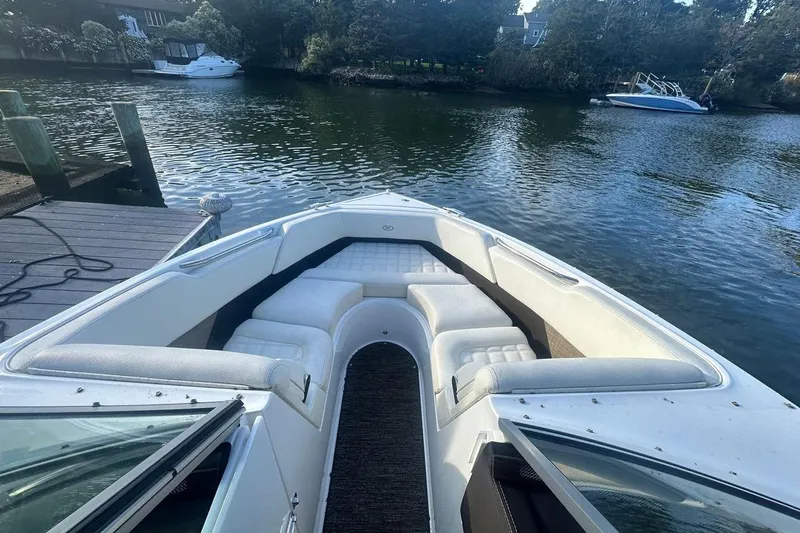 Slide: The Image of 2021 Cobalt R3 boat with white seating, docked on a calm lake. - 20