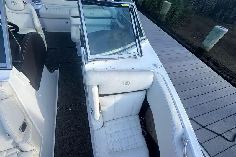 Slide: The Image of 2021 Cobalt R3 boat interior with white seating, docked on a wooden pier. - 22