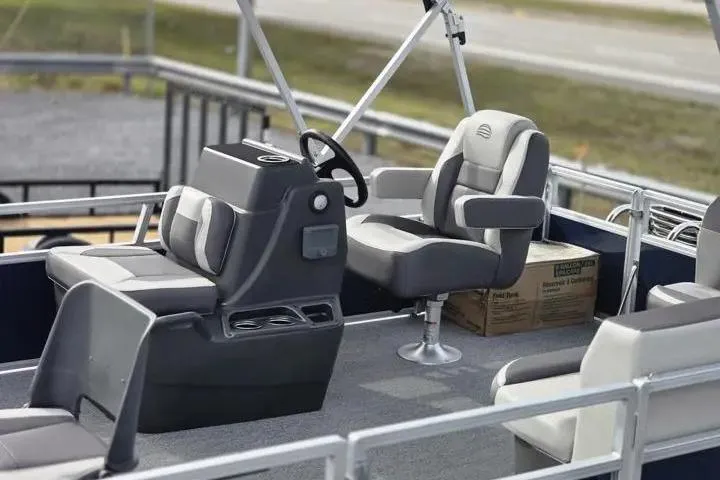 Slide: The Image of 2026 Sun Tracker Bass Buggy 16 XL Select interior with seating and steering console. - 3