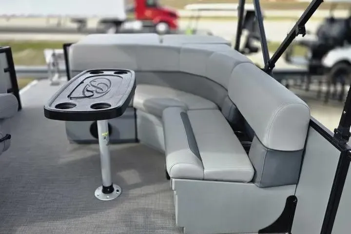 Slide: The Image of 2026 Sun Tracker Bass Buggy 16 XL Select pontoon boat with gray seating and table. - 5