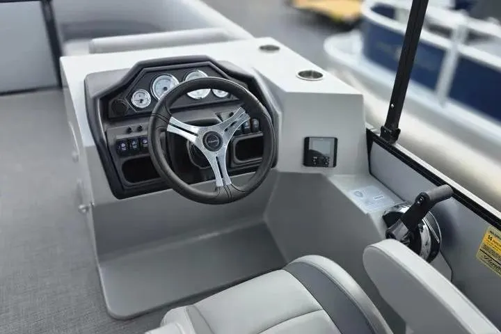 Slide: The Image of 2026 Sun Tracker Bass Buggy 16 XL Select boat dashboard with steering wheel and controls. - 9