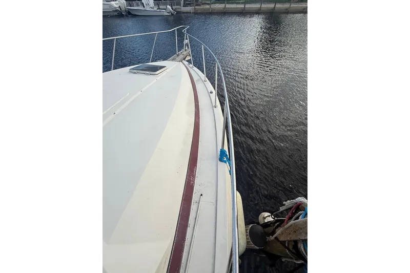 Slide: The Image of 1986 Chris-Craft 336 Commander boat deck view, docked on calm water. - 12