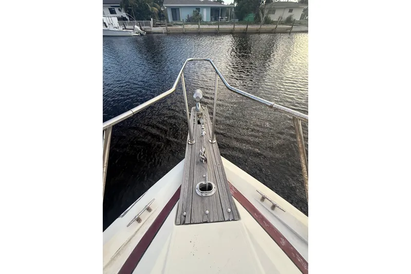 Slide: The Image of 1986 Chris-Craft 336 Commander boat bow view on calm water. - 14