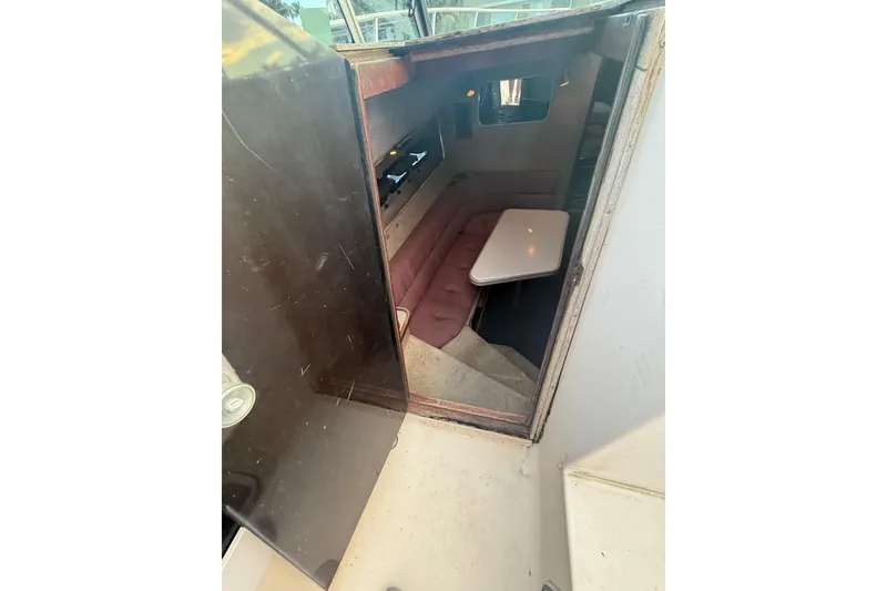 Slide: The Image of Interior view of 1986 Chris-Craft 336 Commander cabin with seating and table. - 17