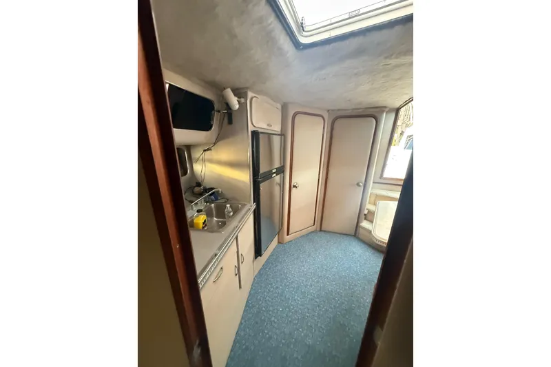 Slide: The Image of 1986 Chris-Craft 336 Commander interior with kitchenette and seating area. - 24