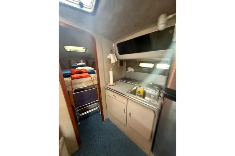 Slide: The Image of 1986 Chris-Craft 336 Commander interior with kitchenette and sleeping area. - 26