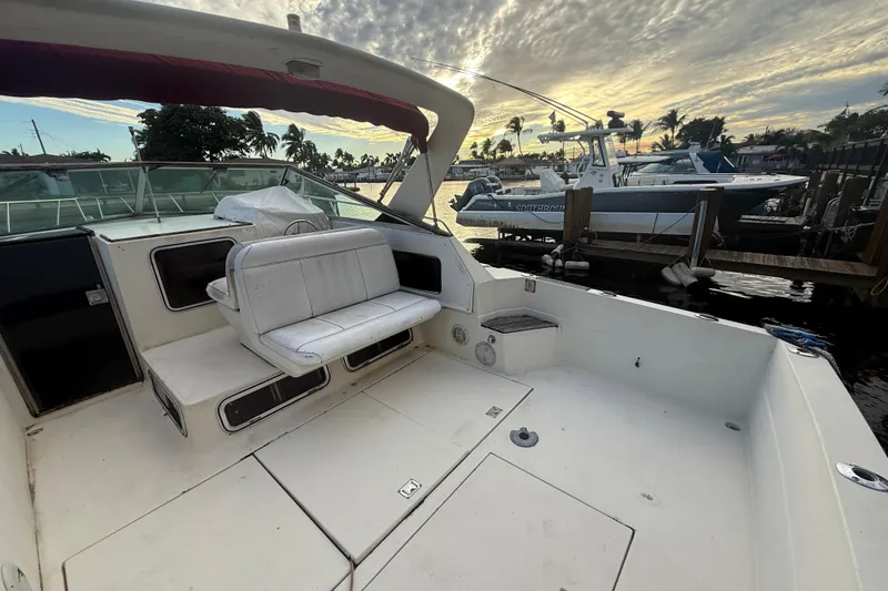 Slide: The Image of 1986 Chris-Craft 336 Commander boat interior with seating, docked at sunset. - 8
