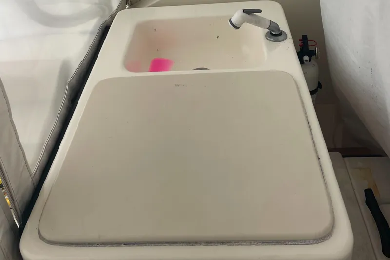 Slide: The Image of 2004 Carolina Classic 28 boat sink with faucet and cover. - 17