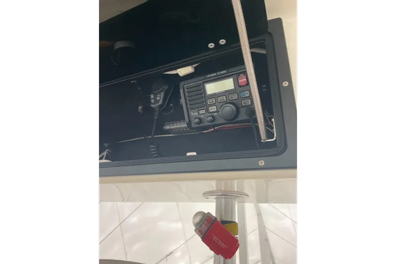 Slide: The Image of 2004 Carolina Classic 28 boat radio equipment in storage compartment. - 21