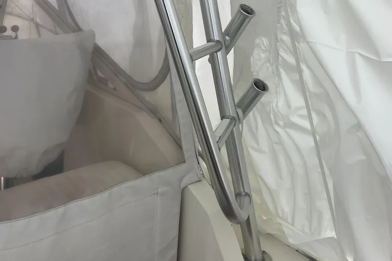 Slide: The Image of Interior view of a 2004 Carolina Classic 28 boat, featuring metal rod holders. - 24
