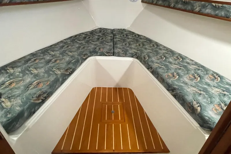 Slide: The Image of 2004 Carolina Classic 28 cabin interior with patterned cushions and wooden flooring. - 35