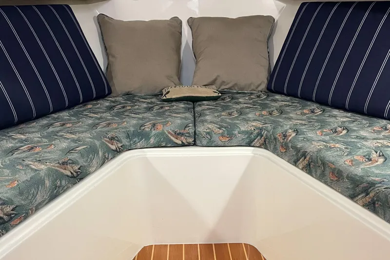 Slide: The Image of Interior cabin of a 2004 Carolina Classic 28 boat with patterned cushions. - 36