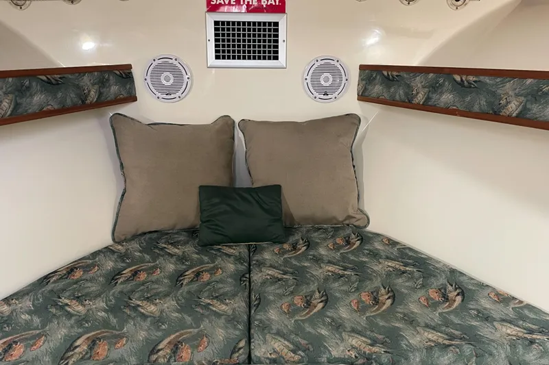 Slide: The Image of 2004 Carolina Classic 28 cabin interior with patterned cushions and pillows. - 37