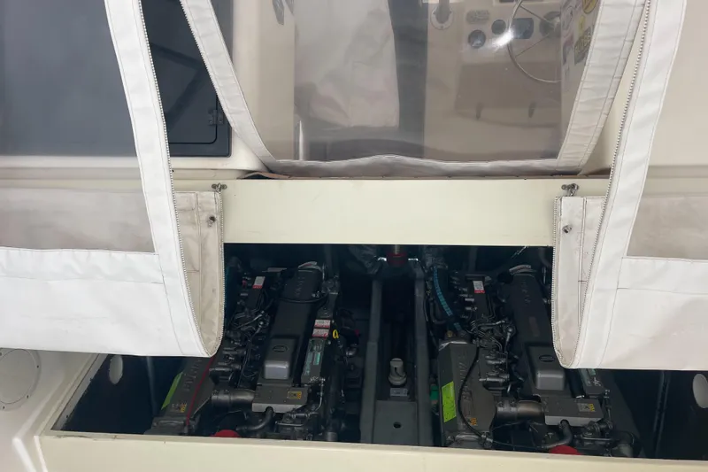 Slide: The Image of Engine compartment of a 2004 Carolina Classic 28 boat, showcasing dual engines. - 39