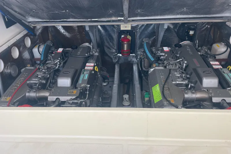 Slide: The Image of Engine compartment of a 2004 Carolina Classic 28 boat, featuring dual inboard engines. - 40