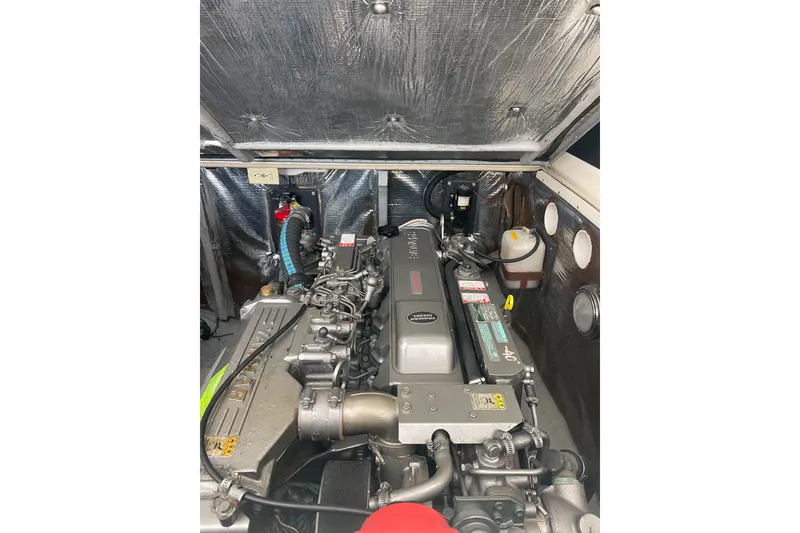 Slide: The Image of Engine compartment of a 2004 Carolina Classic 28 boat, showcasing detailed machinery. - 41