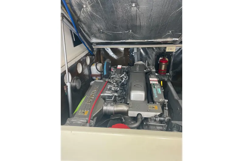 Slide: The Image of Engine compartment of a 2004 Carolina Classic 28 boat, showcasing detailed machinery. - 42